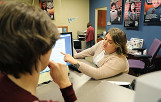 Woman Pointing to Her Computer Screen