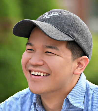 Asian male student with a hat on his head