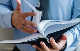 A Man Looking Through a Binder