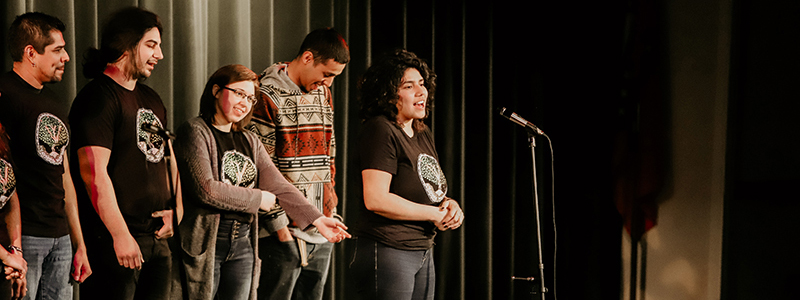 Students standing on a stage.