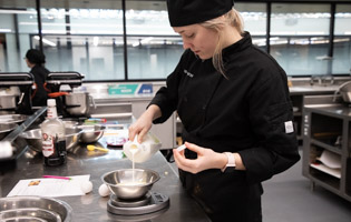Culinary Student Pouring Milk
