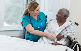 Female CNA Assisting a Female Patient in Wheelchair