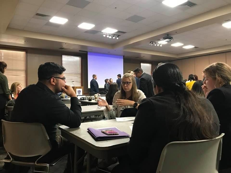 Students Sitting at Tables at Conference