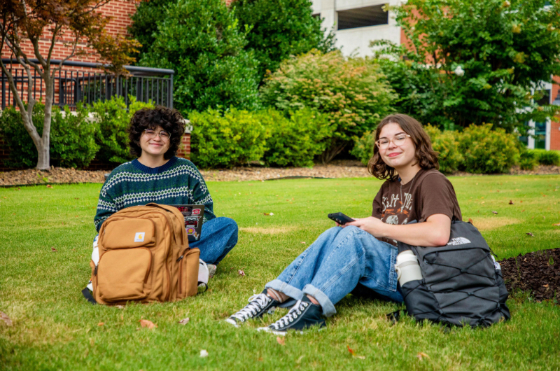 Two NWACC students studying in lawn.