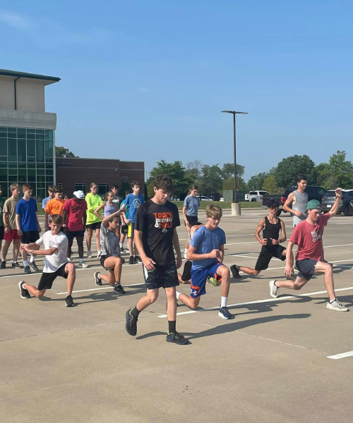 Children in a parking lot, stretching and exercising