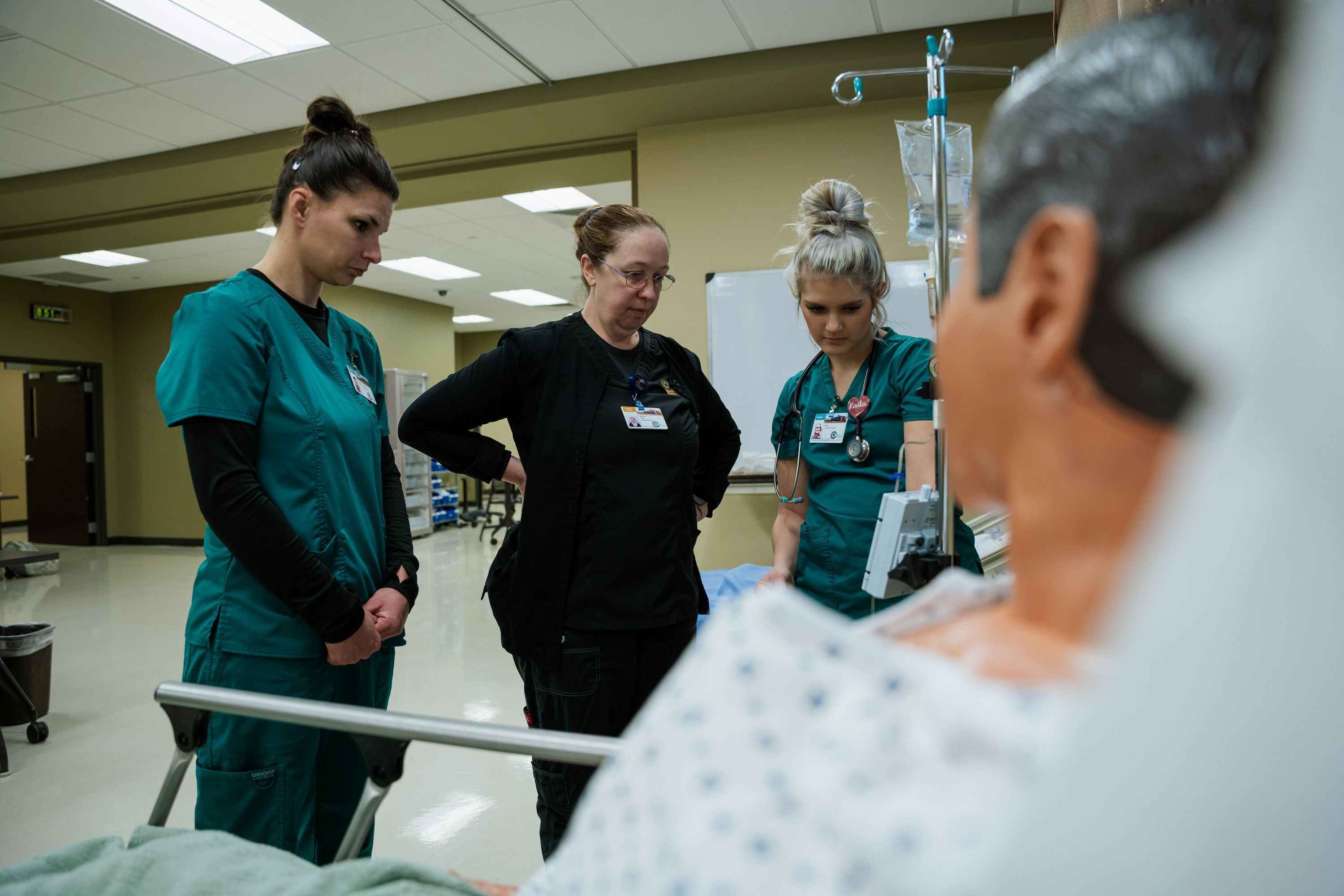 Nursing Student Gathered Around Viewing a Patient 