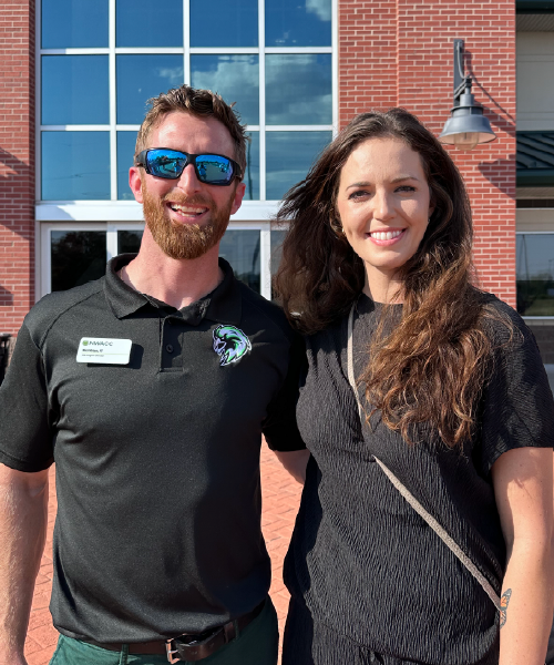 Man in sunglasses next to woman in black shirt