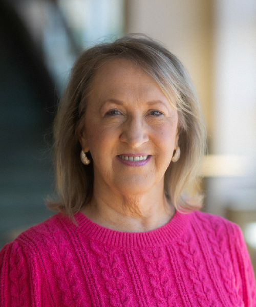 Smiling woman wearing a pink shirt