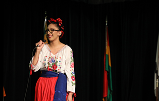 Hispanic Woman Speaking on Microphone