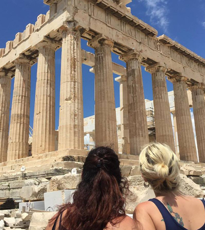Two Women Looking Up at the Greek Acropolis
