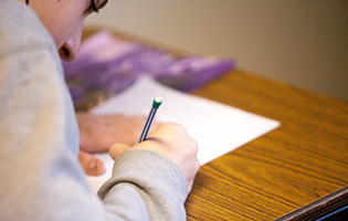 Woman Writing on Paper