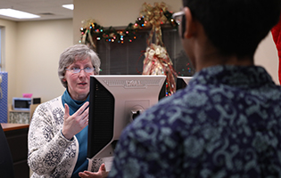 Staff Assisting a Student