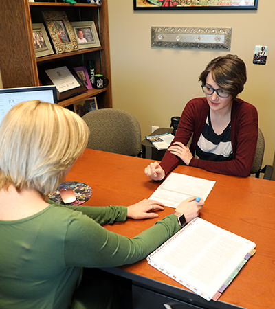 Female student talking to a female advisor.